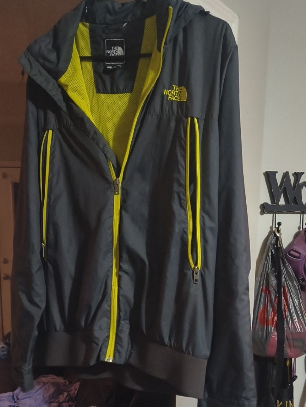 The North Face Black Jacket with Yellow Trim and Mesh Lining